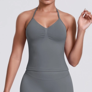 Close-up of grey halter V-neck sports bra featuring ruched detail and elastic knit fabric