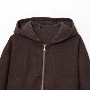 Deep brown hooded zip-up jacket with thick knit texture and minimalist metal zipper