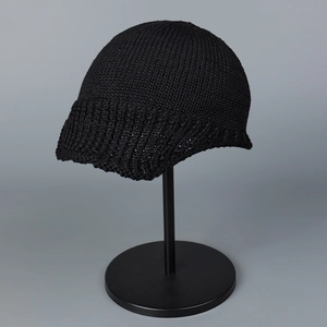 Macro view showing the detailed breathable black knitted texture of the summer aviator hat