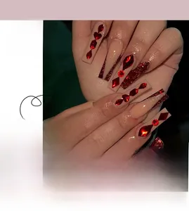 Detailed view of long coffin press-on nails with red heart rhinestones and glitter finish