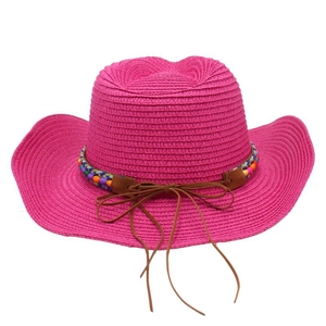 Detailed texture of rose pink straw cowboy hat with colorful beaded band and bow