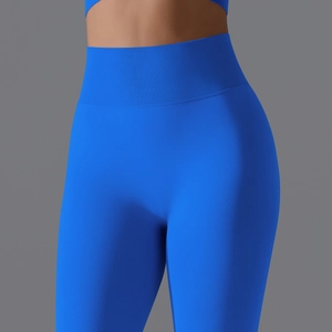 Detailed close-up of blue high-waisted seamless ribbed yoga pants with a peach lift effect