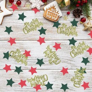 Golden glitter Merry Christmas confetti with red and green stars on white wood surface