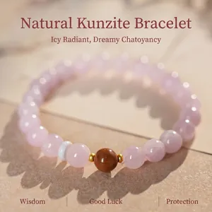 Pink kunzite beaded bracelet with gold spacers and reddish-brown accent bead detail