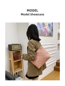 Pink quilted tote bag with gold chain strap shown on model in cozy room setting