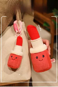 Detail of red lipstick plush doll with embroidered smile and keychain charm on woven bag