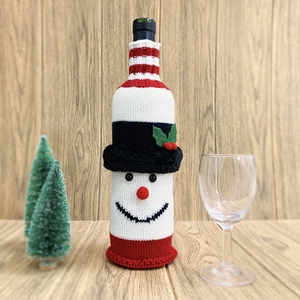 Knitted snowman wine bottle cover decoration for Christmas table settings and holiday gifts