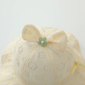 Lace baby sun hat with floral embroidery and tulle bow in a soft yellow color