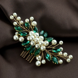 Detail of bridal hair comb with emerald marquise crystals and white pearls on gold wire