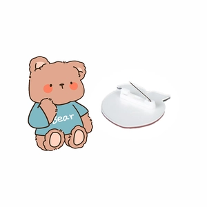 Cute brown acrylic cartoon bear brooch with blue shirt and metal pin on white background