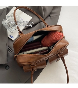Detailed view of spacious brown vintage bowling bag interior holding various daily essentials