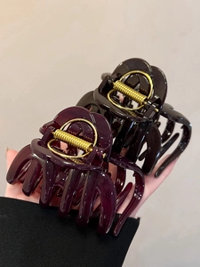 Detail of large acrylic pumpkin claw clip set showing strong metal spring and glossy finish