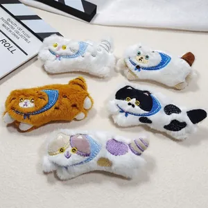 Close-up of five cute plush cat pins with detailed embroidery and blue scarves for DIY crafts