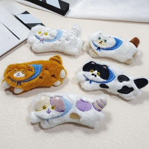 Close-up of five cute plush cat pins with detailed embroidery and blue scarves for DIY crafts