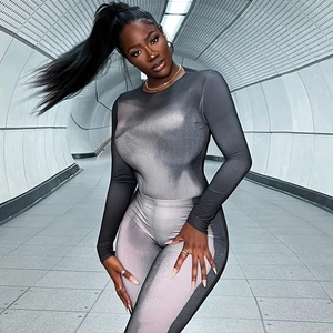 Close-up of the black and gray gradient pattern and slim fit design on a long sleeve jumpsuit