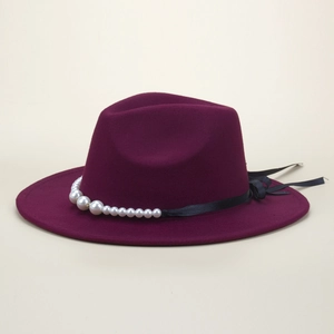 Detail of burgundy wool fedora featuring elegant pearl trim and black satin ribbon detail