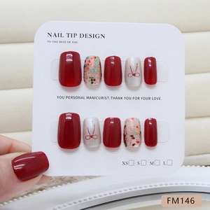 Faux ongles faits main œil de chat avec nœuds rouges et paillettes colorées