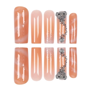 Gradient orange press-on nails with silver bear pendant and heart chain detail