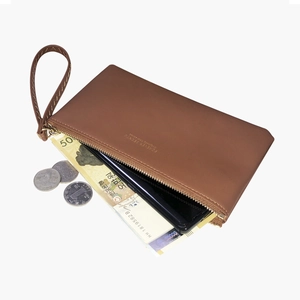 Brown leather slim long wallet showing interior space with phone and bills for storage