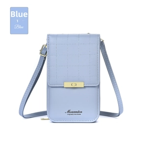 Detail of blue quilted crossbody phone bag with a gold rectangular metal lock