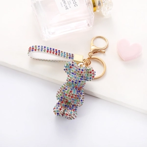 Close-up of a colorful rhinestone bear keychain with gold metal clasp and luxury lanyard