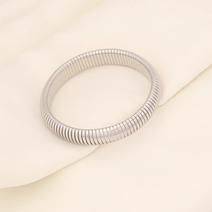 Detail of silver flexible stretch tube bracelet with smooth metallic texture