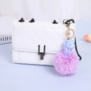 Unicorn plush ball keychain with pink faux fur and purple silicone charm for handbags
