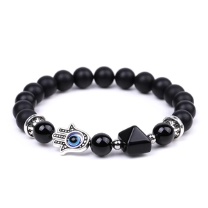 Detail of beaded bracelet with black onyx, Fatima hand charm, and pyramid pendant