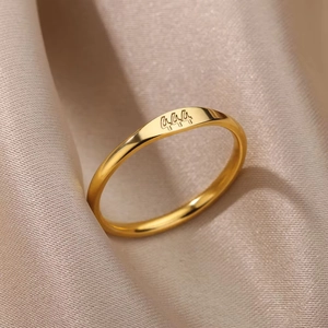 Macro shot of gold stainless steel ring with 444 angel number engraving on silk background