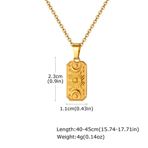 Detailed view of vintage gold rectangle pendant necklace with sun and moon celestial motifs