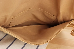 Detail of paper rope woven bag featuring brown fabric lining and inner pocket