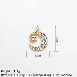 Detailed view of 1.7cm moon and star alloy pendant with white rhinestones and gold plating