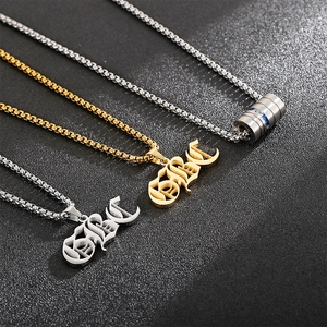 Detail view of gold and silver dumbbell pendants and Kobe necklaces on black background