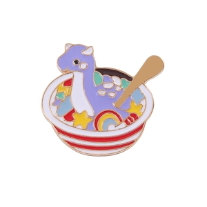 Cute purple dragon enamel brooch pin inside a decorative bowl with stars and rainbow