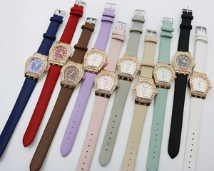 Close-up of elegant ladies quartz watches with rhinestone bezels and colorful leather straps