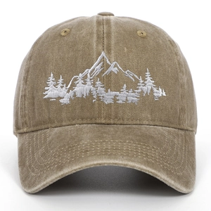 Detailed mountain and forest embroidery on washed cotton baseball cap with textured finish
