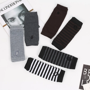 Flat lay of colorful striped knitted fingerless long arm sleeves in various neutral tones