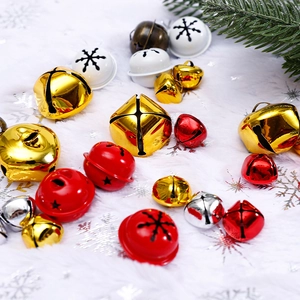 Colorful Christmas bell assortment with snowflake cutouts on white faux fur background
