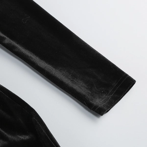 Macro shot of black velvet sleeve cuff showing soft texture and glossy fabric finish
