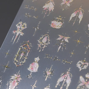 Embossed 3D nail art sticker featuring golden vintage crowns and bows with pink accents