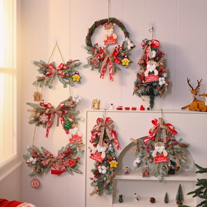 Detailed view of Christmas garlands with red berries, pine needles, and festive ribbons