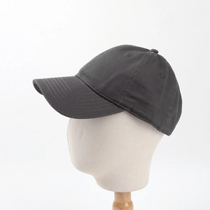 Detailed side view of a dark grey six-panel cotton canvas baseball cap on a white model head