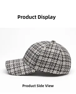 Detailed side view of black and white plaid baseball cap with woven tweed texture