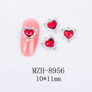 Macro view of 10x11mm heart-shaped red nail gems with silver alloy frames