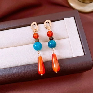 Detail of vintage bohemian earrings with agate beads and teardrop pendants in a box