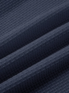 Macro shot of dark blue waffle texture fabric on men's slim fit breathable sports T-shirt