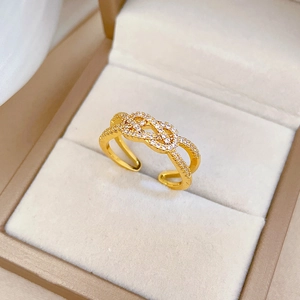 Gold plated criss-cross twisted open ring with micro-pave cubic zirconia stones