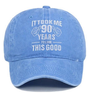 Detail of white embroidery text on washed blue cotton baseball cap with thumb icon