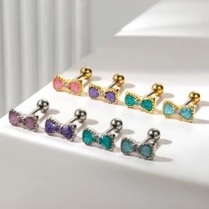 Macro detail of butterfly earrings with colorful glitter coating and sparkling crystals