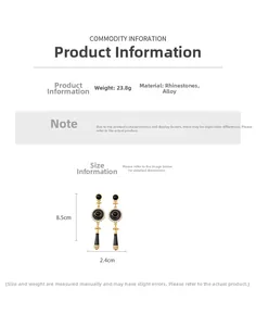 Detail view of vintage gold alloy earrings with black stones and rhinestones showing 8.5cm length